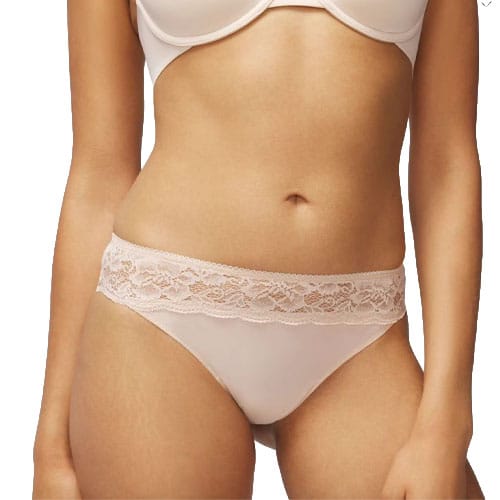 A model is wearing a light pink bra and matching panties featuring a lace waistband.