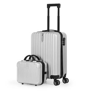 A silver hard-shell luggage set with a rolling suitcase and a smaller handheld case, featuring a ribbed texture and a telescopic handle.