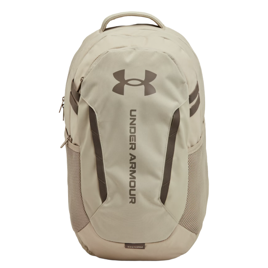 Under Armour beige backpack with a top handle, large logo, side mesh pockets, and zippered compartments.