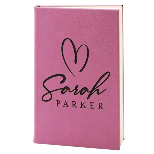 Pink journal with a heart design and \“Sarah Parker\“ printed in black lettering on the cover.