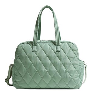 A large, quilted weekender travel bag in a muted green color with dual handles and a detachable shoulder strap. The bag features a spacious main compartment and a diamond-patterned stitching design.