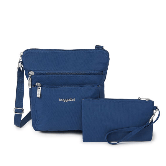 A blue crossbody bag with front zipper pockets and an adjustable strap, accompanied by a matching wristlet pouch.