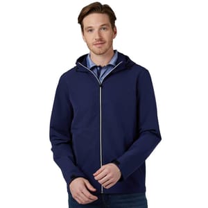 A man wears a blue hooded jacket over a collared shirt, paired with jeans.