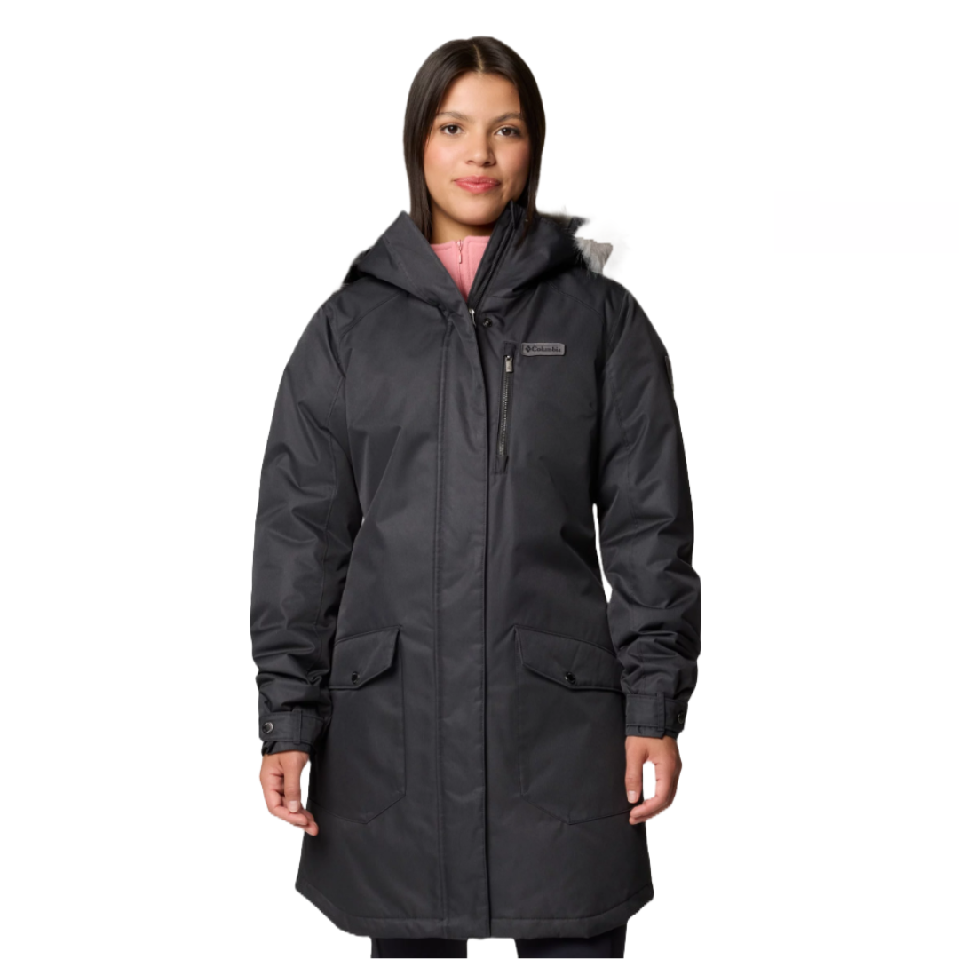 A woman is wearing a black hooded winter coat with front pockets and a zipper closure. The coat has a logo on the chest.