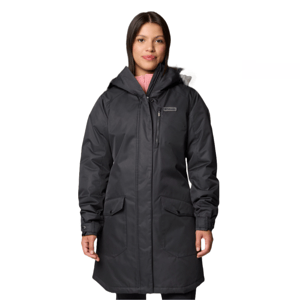 A woman is wearing a black hooded winter coat with front pockets and a zipper closure. The coat has a logo on the chest.