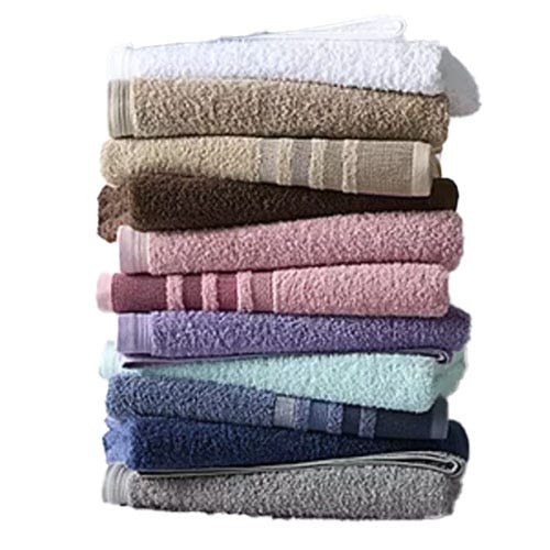 A stack of multi-colored bath towels, including white, beige, brown, pink, purple, blue, and gray, neatly arranged in layers.
