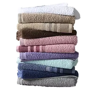 A stack of multi-colored bath towels, including white, beige, brown, pink, purple, blue, and gray, neatly arranged in layers.