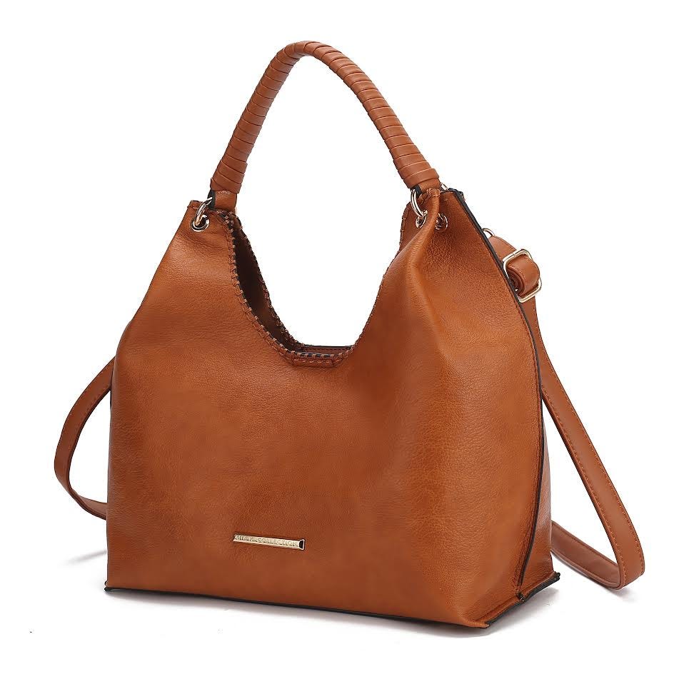 A brown leather handbag features a structured design with a looped handle and an optional shoulder strap. A small metal label embellishes the front.