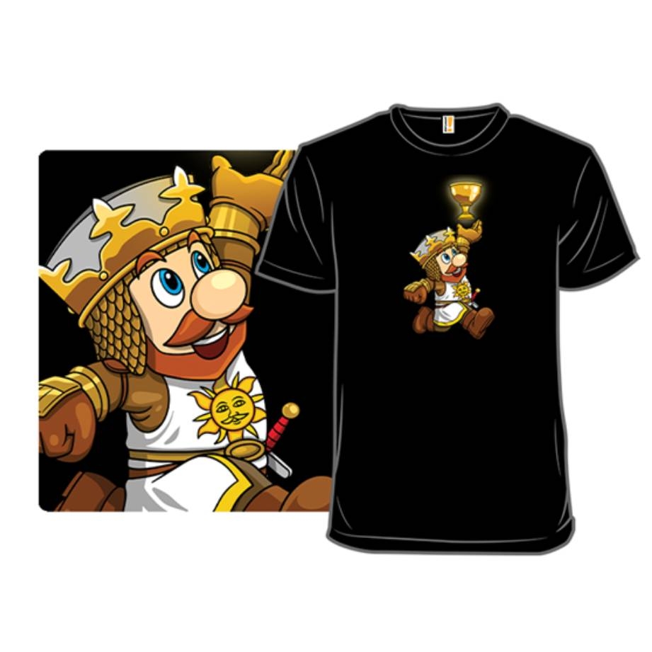 A black T-shirt features a cartoon character resembling a knight with a crown, holding a golden grail and wearing armor with a sun emblem.