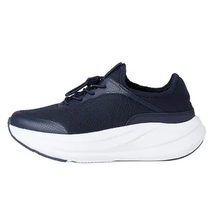 A navy sneaker with a knit texture and a thick white sole, featuring a lace-up design for adjustable fit.