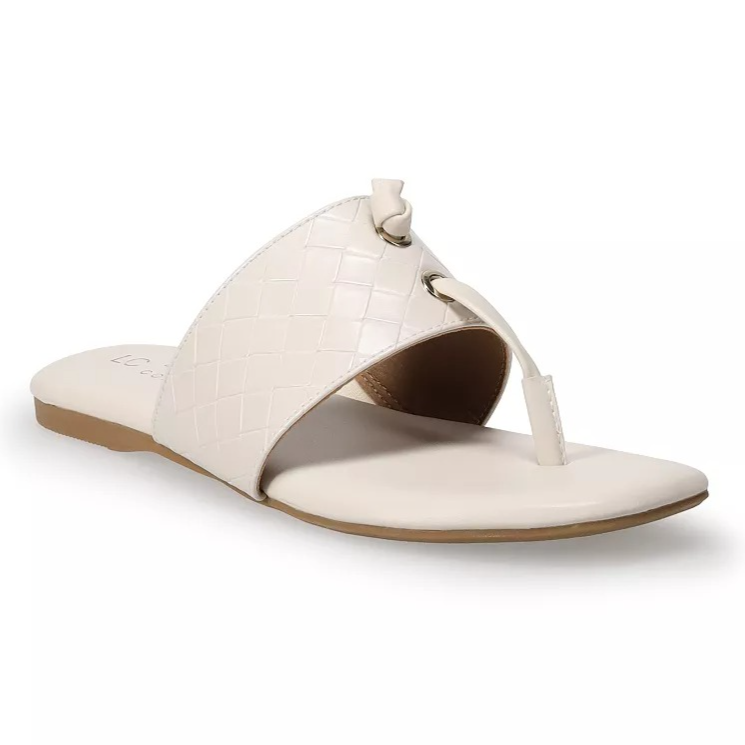 A cream-colored woven texture thong sandal with a flat sole and wide strap design.