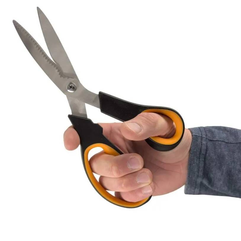 Hand holding a pair of scissors with black and yellow handles.