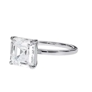 A ring featuring a square-cut diamond set in a simple, elegant metal band.