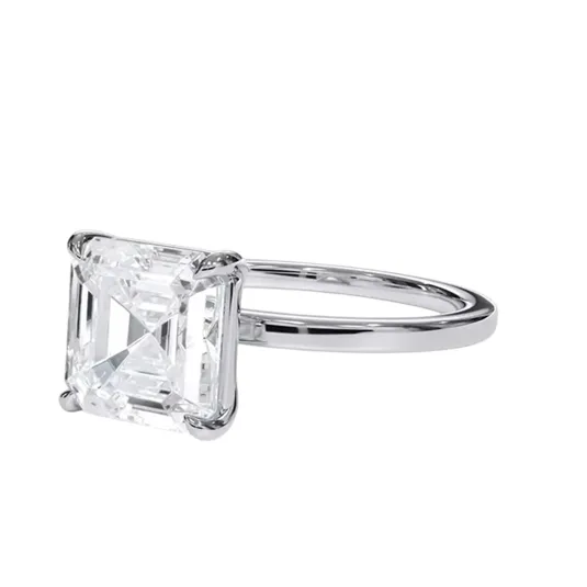 A ring featuring a square-cut diamond set in a simple, elegant metal band.