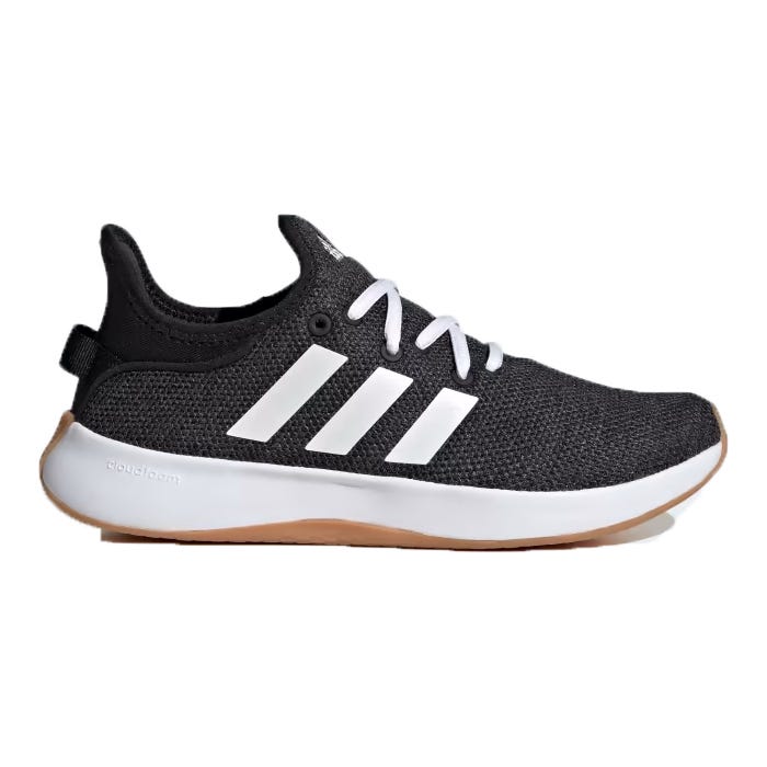 A black and white athletic shoe with a breathable mesh top and a brown sole.