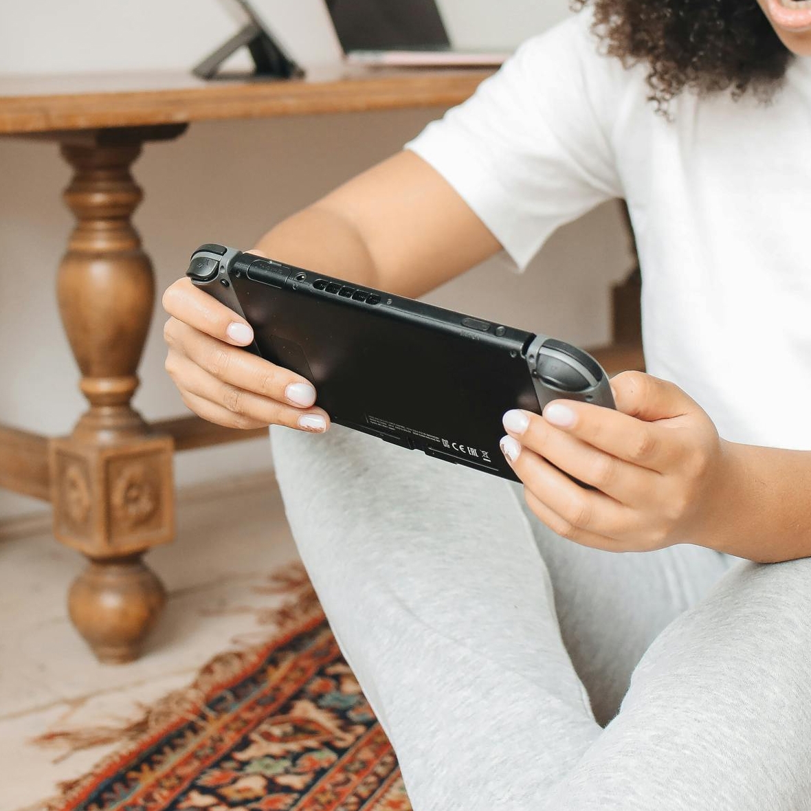 A person is holding a portable gaming console, ready to play.