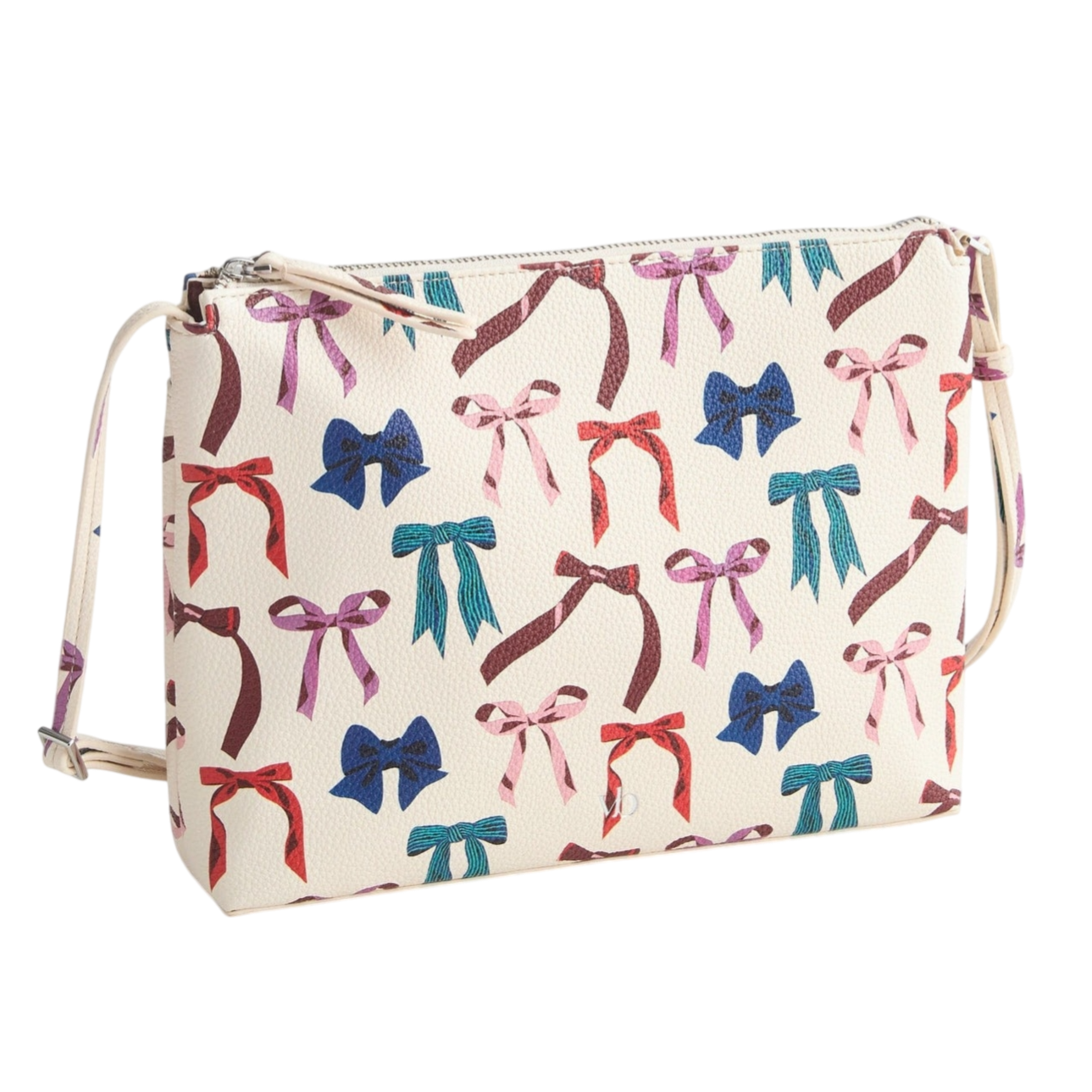 A white crossbody bag with a colorful bow print in red, blue, turquoise, and pink, featuring a zip closure and adjustable strap.