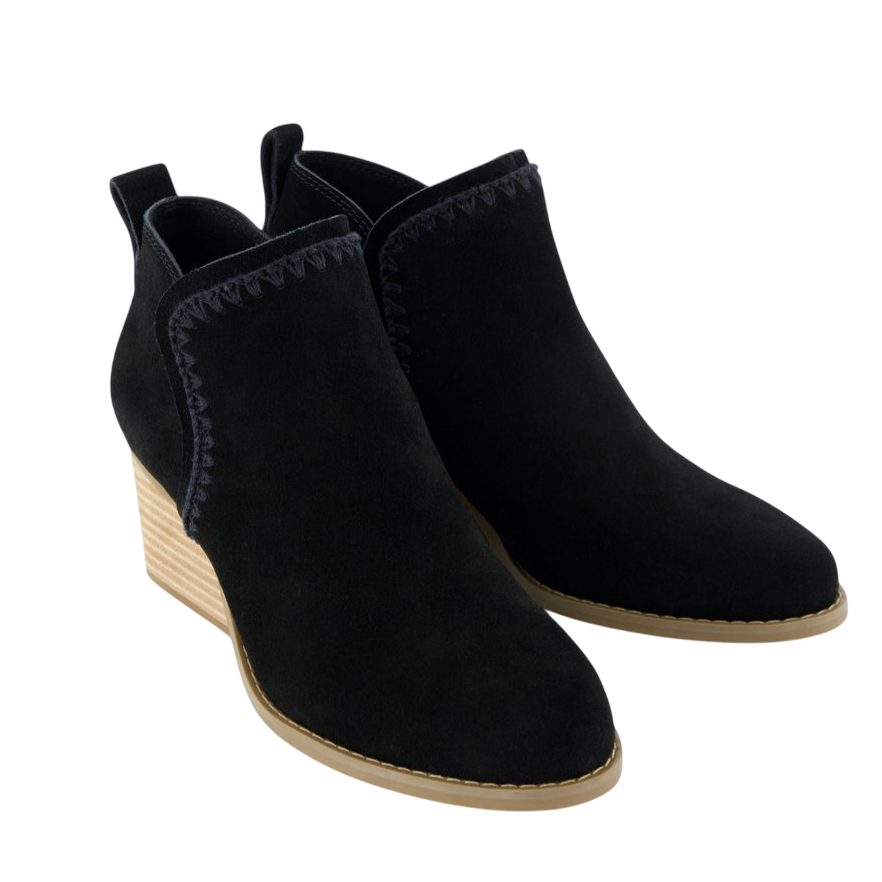 Black suede ankle boots with a wedge heel and a light brown sole, featuring decorative stitching along the upper edge.
