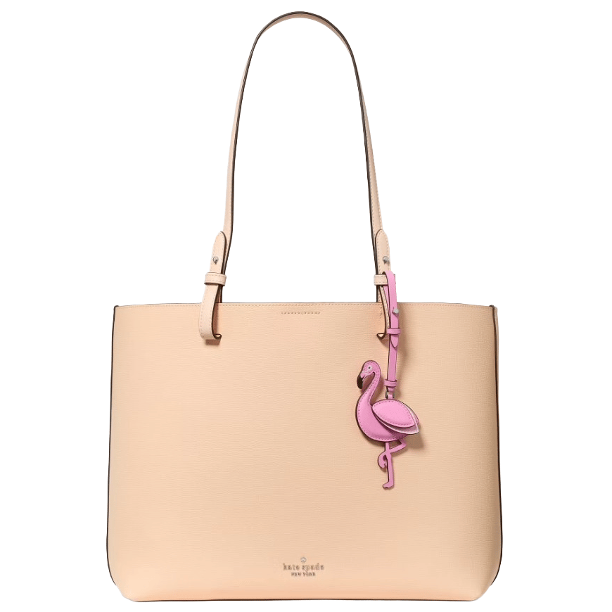A beige Kate Spade New York tote bag featuring a pink flamingo charm accessory.