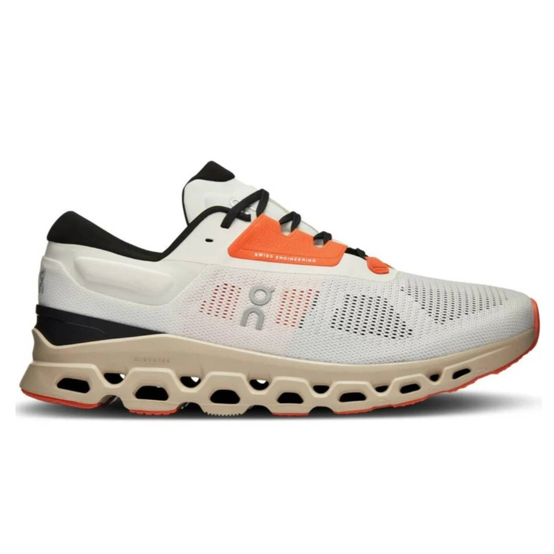 A pair of On Cloudstratus running shoes with dual-tone beige and white upper, black heel support, and a distinctive orange lace loop.
