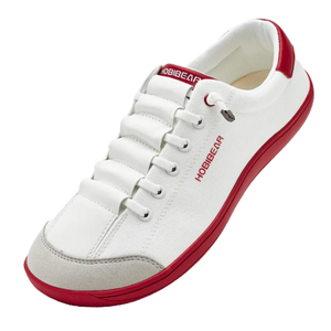A white sneaker with red accents and \“HOBIBEAR\“ branding on the side and tongue, features a white lace-up design and a red sole.