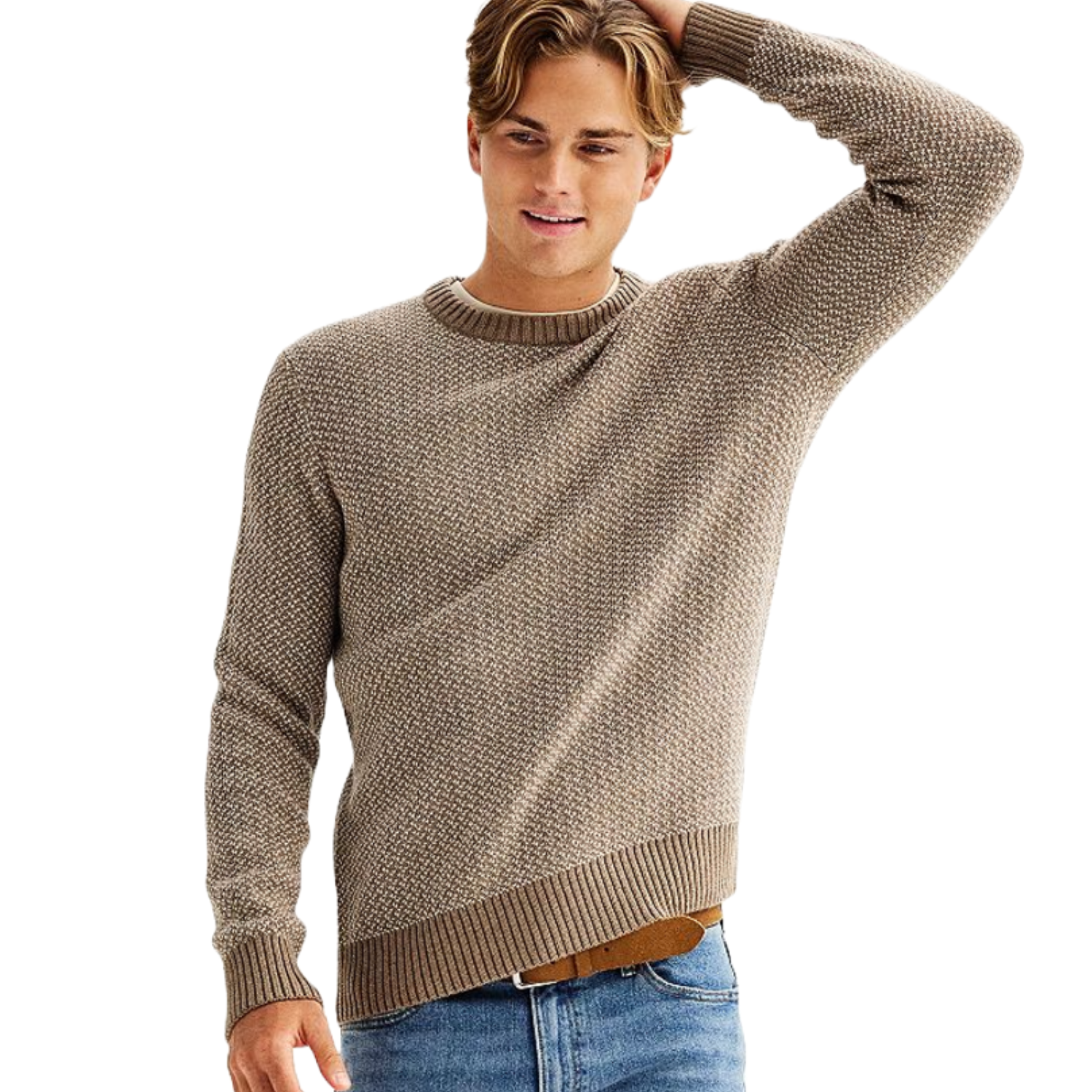A man wears a beige Birdseye crewneck sweater with a textured pattern and ribbed cuffs, hem, and collar, paired with light blue jeans.