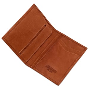 Brown slim leather vertical wallet with multiple card slots and a pocket for bills, featuring embossed text \“JOHN CANDOR EST. 2009\“ on the inside.