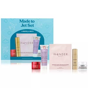 The 5-piece Top-Brand Skincare Set includes a Wander Beauty Baggage Claim Rose Gold Eye Mask, First Aid Beauty KP Bump Eraser Body Scrub, SK-II Cream, Lancôme Absolue Serum, and Kiehl's Ultra Facial Cream.