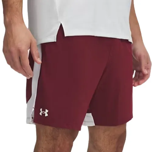 A man wearing maroon Under Armour shorts with a white side stripe and a white top.