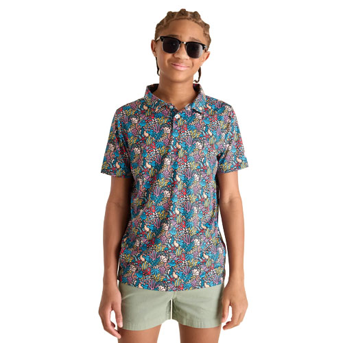 A person wearing a colorful floral-patterned polo shirt, sunglasses, and khaki shorts.