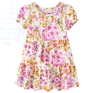 A short-sleeve floral dress with a tiered skirt featuring pink, orange, and green flowers on a white background.