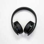 A pair of black over-ear wireless headphones with control buttons on the side.