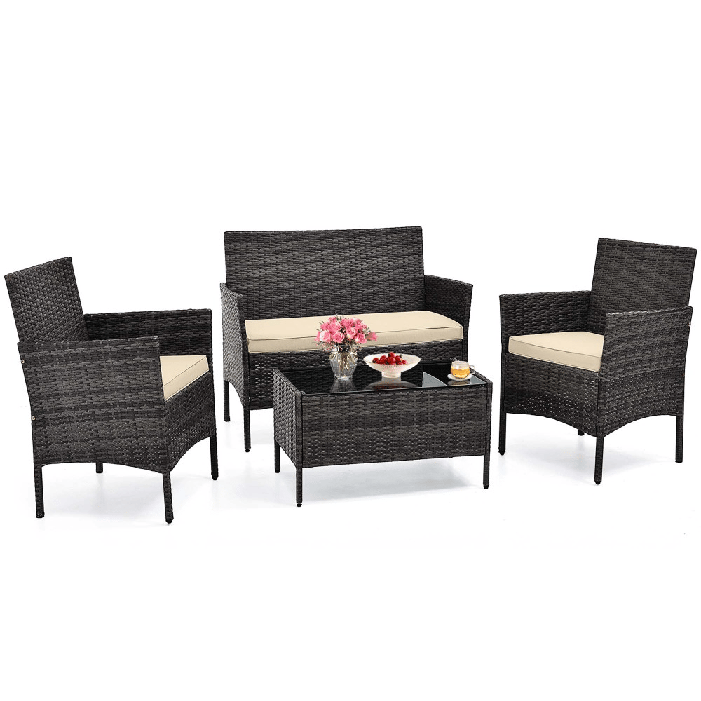 4-piece rattan patio set includes two armchairs, a loveseat, and a glass-top coffee table, all with beige cushions.