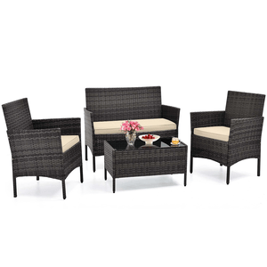 4-piece rattan patio set includes two armchairs, a loveseat, and a glass-top coffee table, all with beige cushions.