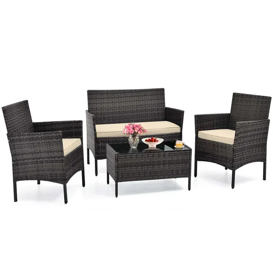 4-piece rattan patio set includes two armchairs, a loveseat, and a glass-top coffee table, all with beige cushions.
