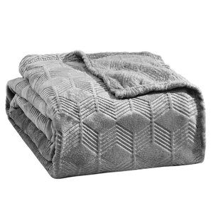 A folded gray plush blanket with a geometric pattern design, featuring textured diamond shapes.
