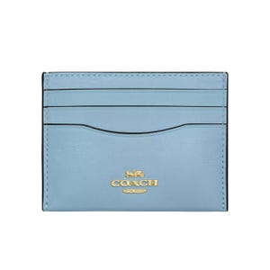 Light blue Coach cardholder with gold logo and multiple card slots.
