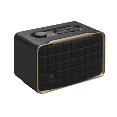 A JBL Bluetooth speaker with a retro design featuring a black quilted front, gold accents, and top-mounted control knobs.