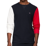 A thermal shirt with a navy blue torso, white left sleeve, and red right sleeve, featuring a small logo on the chest.
