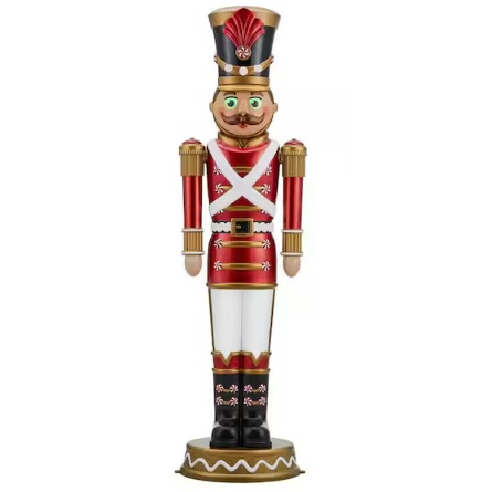 A decorative nutcracker with a red and gold uniform, black boots, and a tall hat.