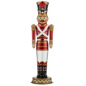 A decorative nutcracker with a red and gold uniform, black boots, and a tall hat.