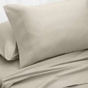 A beige pillowcase and sheet set with a smooth, minimalist design.