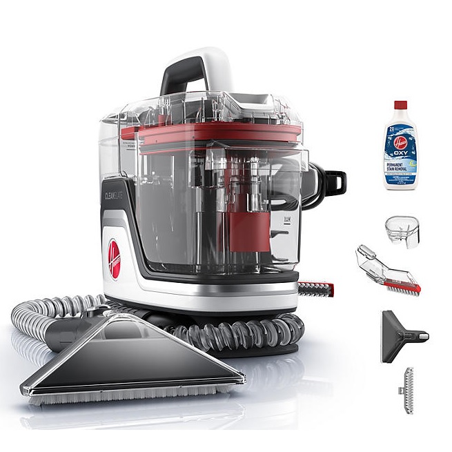 Compact portable carpet and upholstery cleaner with a transparent design, flexible hose, triangular head, and various cleaning attachments, accompanied by a bottle of Oxy stain remover.