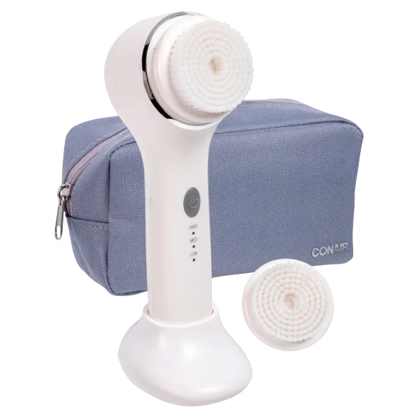 The Conair Sonic Facial Brush Kit includes a white handheld sonic facial brush with a detachable brush head, an additional brush head, and a gray zippered travel pouch.