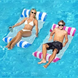 Two people are relaxing on inflatable pool loungers, each with striped blue-and-white and pink-and-white designs, floating in a clear blue pool.