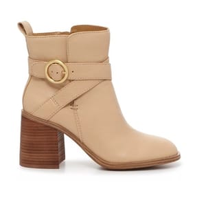 Beige ankle boot with a mid-height block heel and gold buckle strap detail.