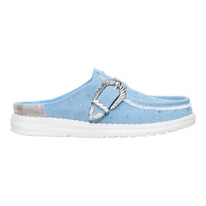 Light blue slip-on clog with a decorative silver buckle and white sole, featuring a textured dotted pattern and a suede-like heel patch.