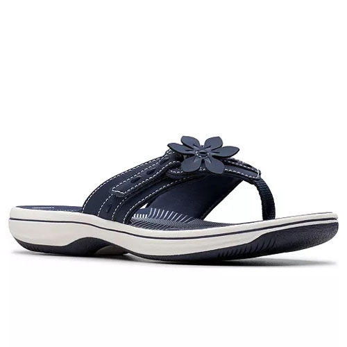 Navy blue thong sandal with a white sole and a flower embellishment on the strap.