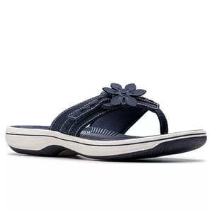 Navy blue thong sandal with a white sole and a flower embellishment on the strap.