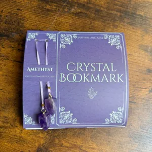 Amethyst crystal bookmark by Sapphire and Sage, featuring purple stones and ribbons, highlighted for spirituality and purification.